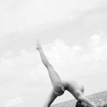 Sexy nude Caucasian woman doing backbend on beach in Maui Hawaii Stock Photo