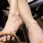 Sexy feet with dangling flipflops